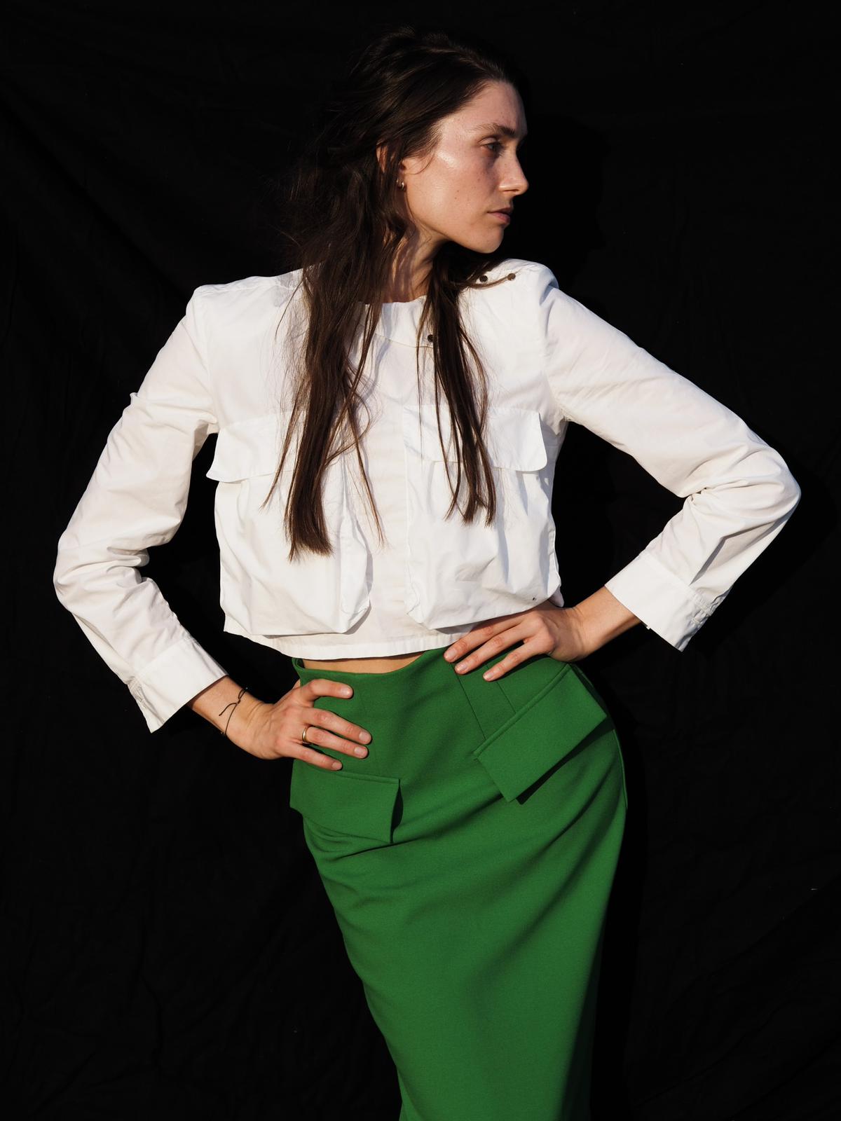 Personal branding portrait of a woman in a white blazer with natural, camera-ready make-up